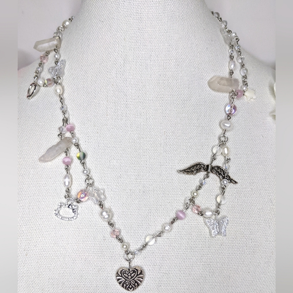 Necklace with pearl and pink crystal beads and a heart pendant. Handmade by me.